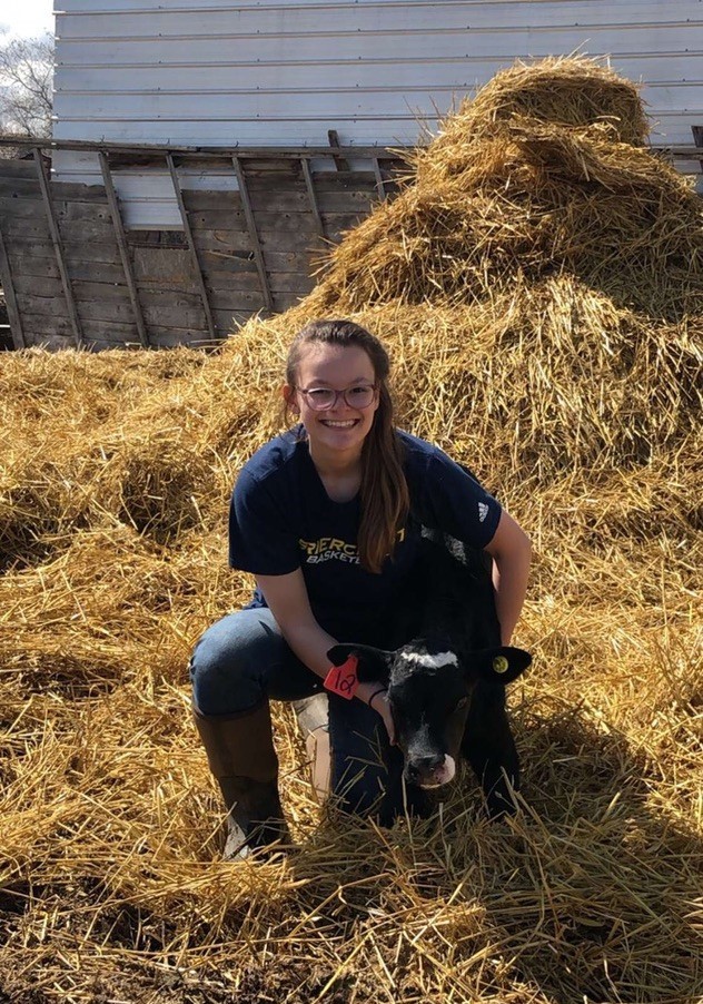 Kylie Grimes working with a calf in the field. (Photo: Submitted)