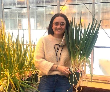 Ariana Forand, USask Master’s student, holding Welsh onions. (Photo: submitted)