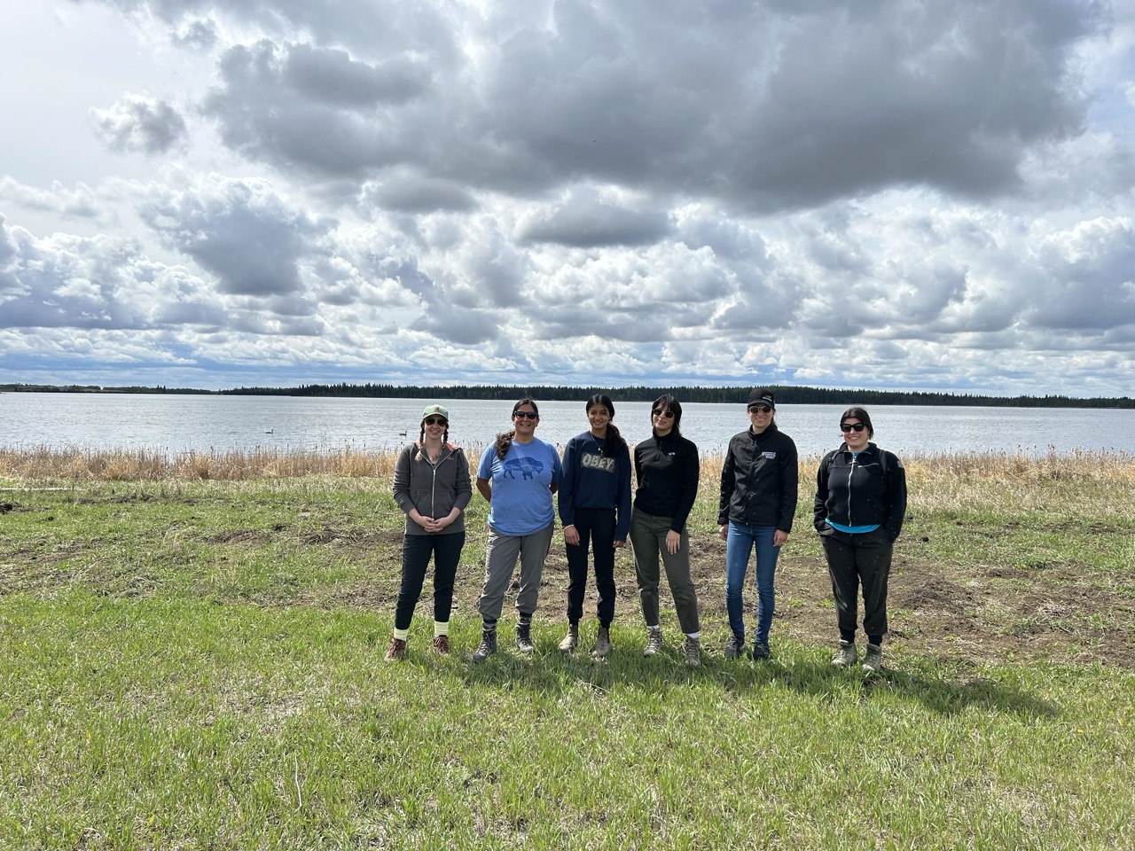 People standing in front of water - Muskeg Lake Cree Nation Garden Workshop