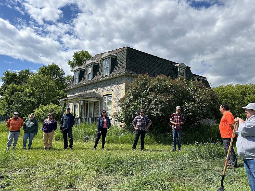 People standing outside of an old building