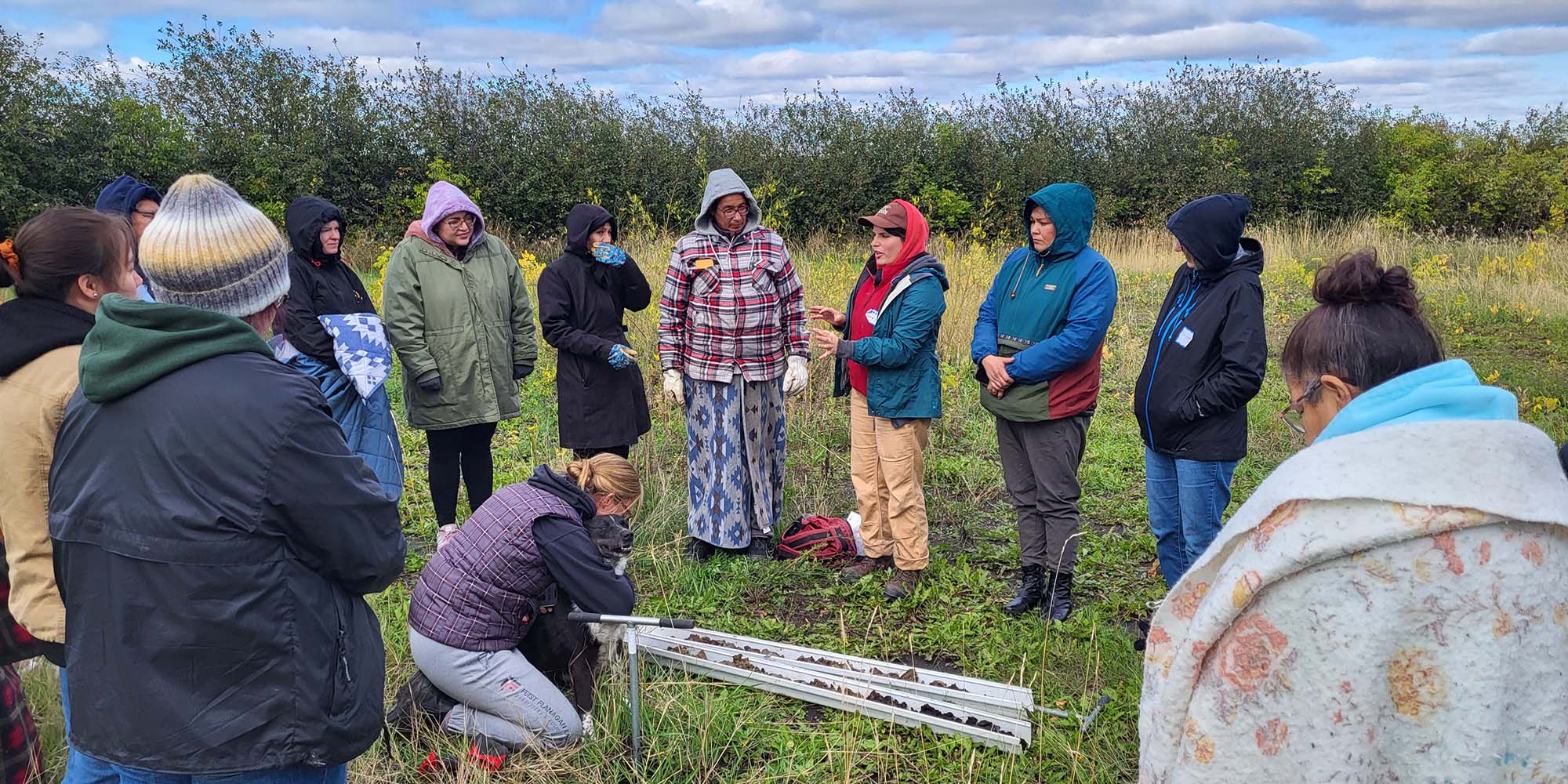 Seed Saving Learning Circle - People standing in a circle talking