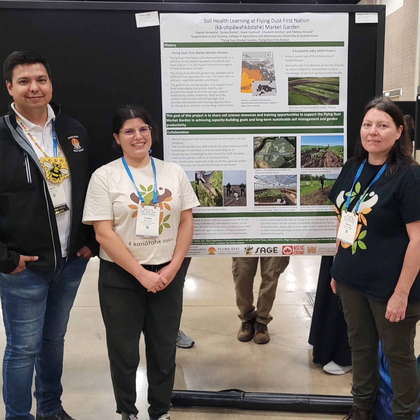 3 people standing in front of a poster presentation