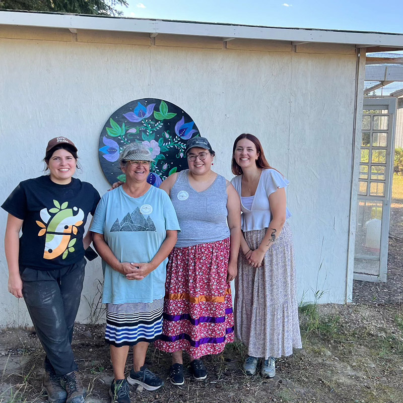 Four people standing in front of a building in Île-à-la-Crosse